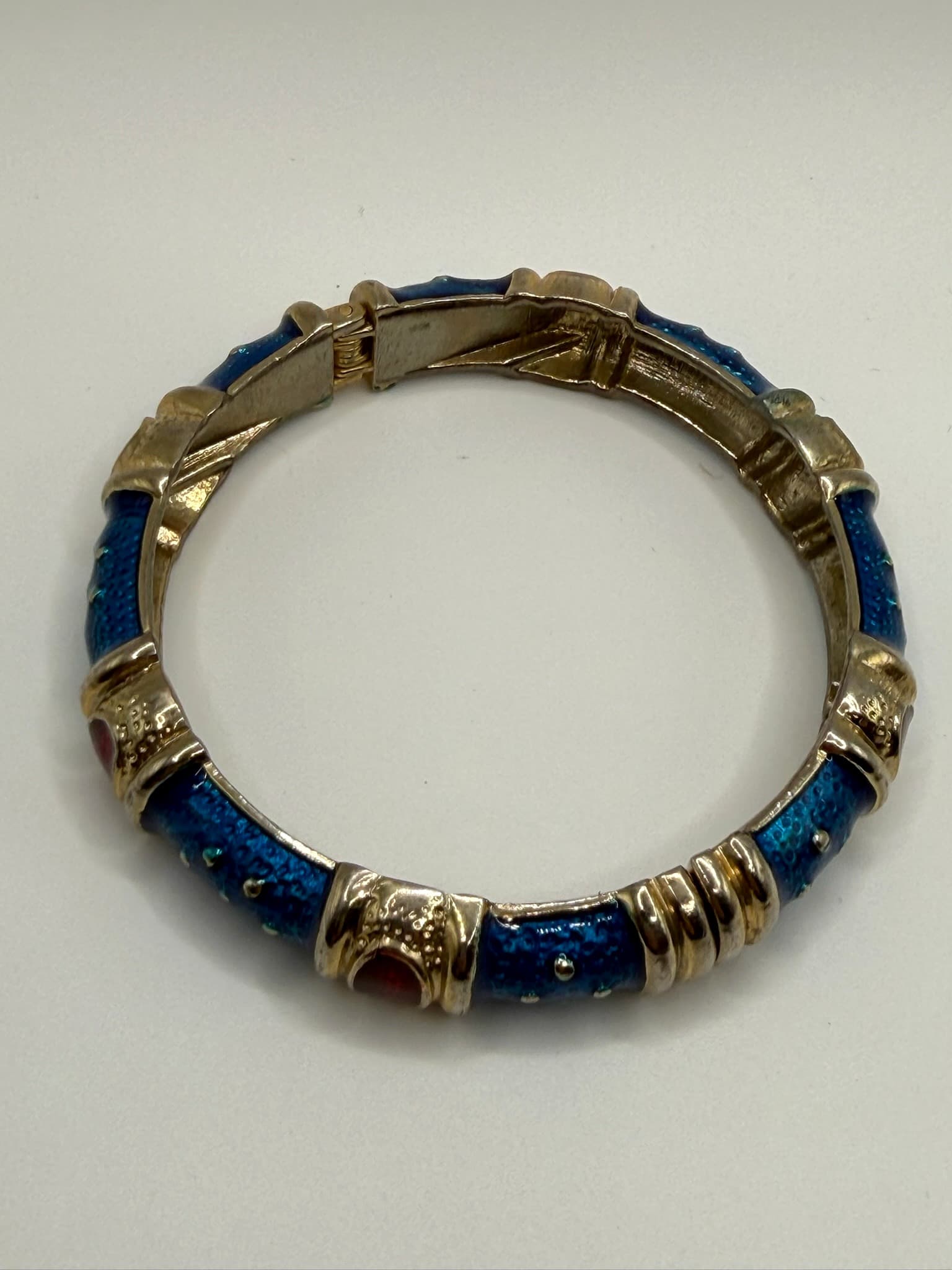 Gold-Tone Blue Enamel Hinged Bangle Bracelet with Red Cabochon Accents